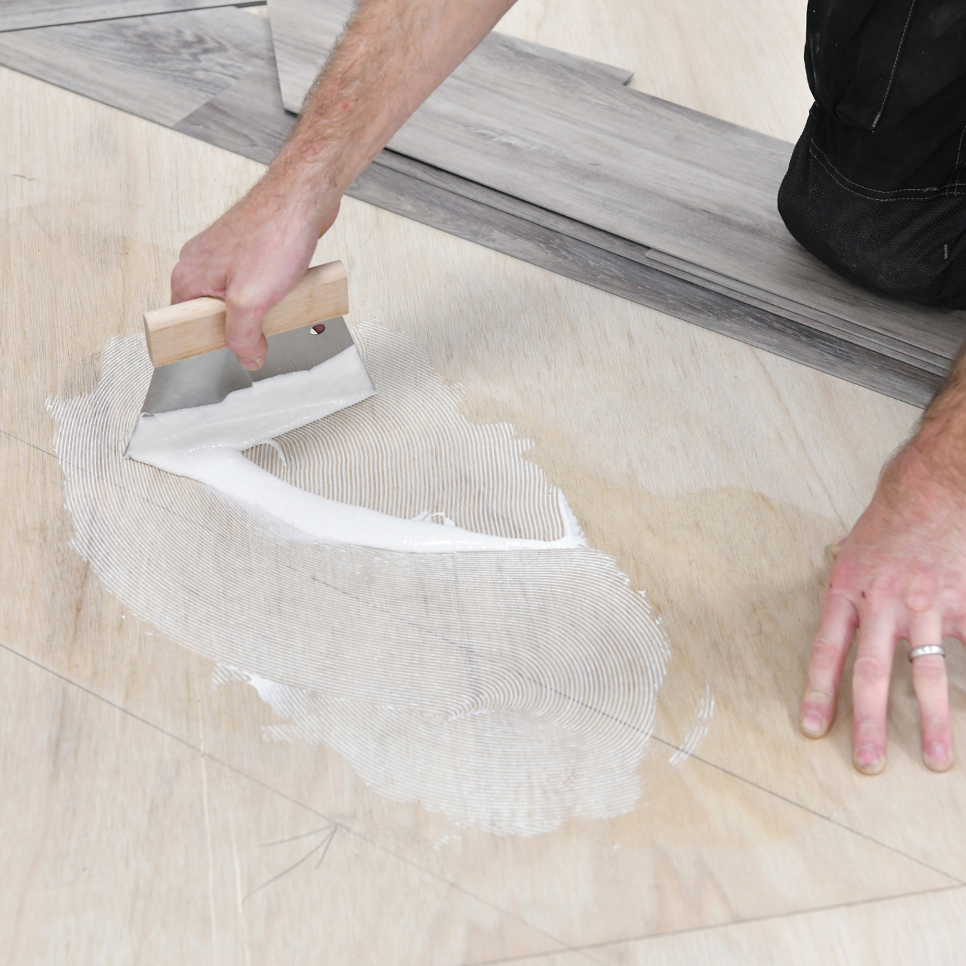 Installer applying a Karndean adhesive to the subfloor